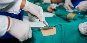 Medical students practicing surgical techniques in a clinical setting.