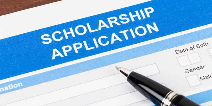 A close-up of a scholarship application form with a pen, representing the process of applying for financial aid.