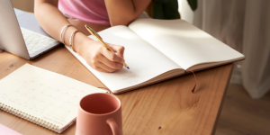 Close-up of a student writing in a notebook during Turkish language prep year studies.
