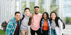 Smiling international students embracing each other on campus in Türkiye.