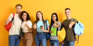Diverse group of international students smiling with thumbs up